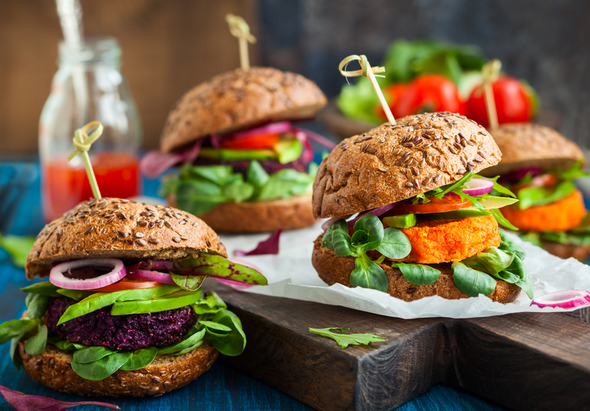 Four thick veggie beet, carrot and avocado burgers on rolls
